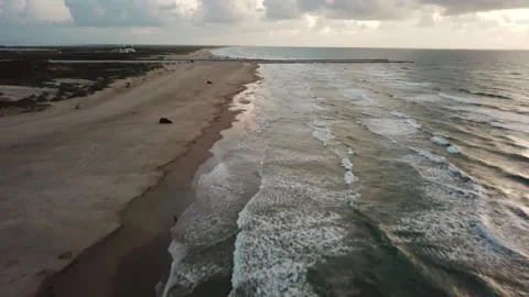 An aerial view, backing up along the beach of Padre Island, Texas Stock Footage 158559339