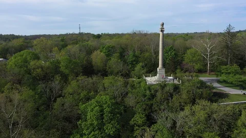 Aerial view backing away from the James Rumsey Monument in Shepherdstown, WV on Stock Footage 129643019