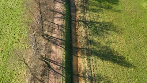 Aerial view from backward flight over a ditch draining wet boggy meadows Stock Footage 171747583