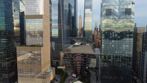 Aerial view backwards in front of high-rise in Hudson Yards, sunset in New York Stock Footage 319937397
