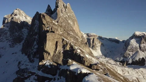 Aerial view backwards a hiker in front of the Seceda ridge, winter sunset Stock Footage 241763557
