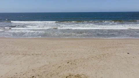Aerial view backwards over a couple on the Venice Beach, in sunny Los Stock Footage 242066043