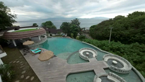 Aerial View of Bali Resort with Infinity Pool and Ocean Stock Footage 337447433