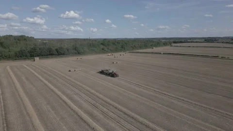 Aerial view of baling machine in wheat field in Derbyshire, England Stock Footage 205931001