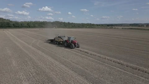 Aerial view of baling machine in wheat field in Derbyshire, England Stock Footage 205931289
