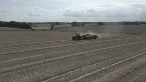 Aerial view of baling machine in wheat field in Derbyshire, England Stock Footage 205931819