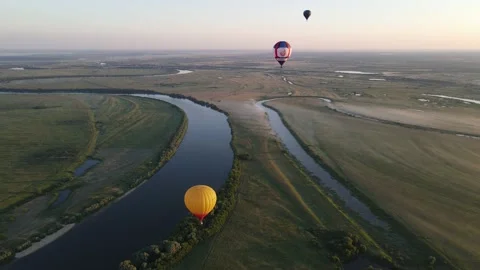 Aerial view of balloons in the sky over the river Stock Footage 202231633