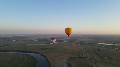 Aerial view of balloons in the sky over the river Stock Footage 202231728