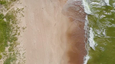 Aerial View of Baltic Sea Waves Crashing on a Sandy Beach in Lithuania Stock Footage 321751978