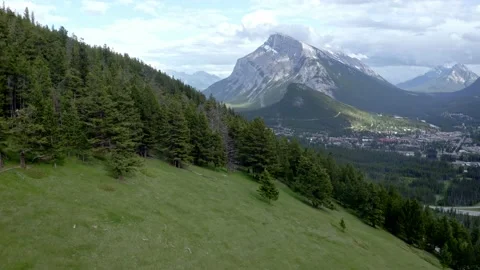 Aerial view of Banff with pine trees and small town and glacier Stock Footage 233289819