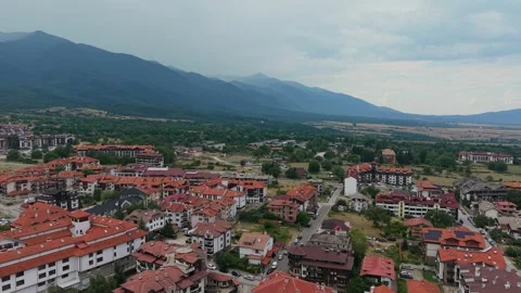 Aerial view of Bansko town with red roofs and mountains in Bulgaria Stock Footage 343641741