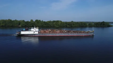 Aerial view. A barge loaded with scrap metal and waste floating on a wide river. Stock Footage 236188927