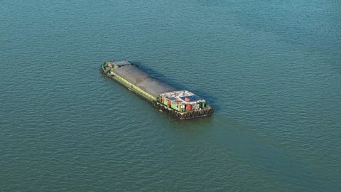 Aerial view of barge navigates river in urban setting with modern skyscrapers Stock Footage 311560050