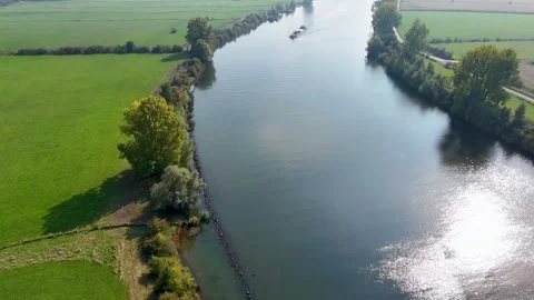 Aerial view of barge navigating a winding river through countryside Stock Footage 320813271