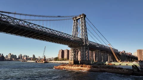 Aerial view of a barge passing under New York's Williamsburg Bridge Stock Footage 254031939