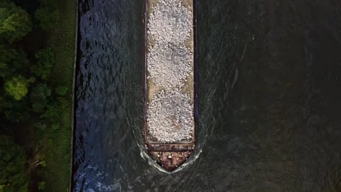 Aerial view of barge with stone construction materials Видео 256933502