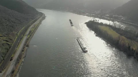 Aerial View Of A Barge Transporting Cargo Across A River With Roads. Video stock 297920987