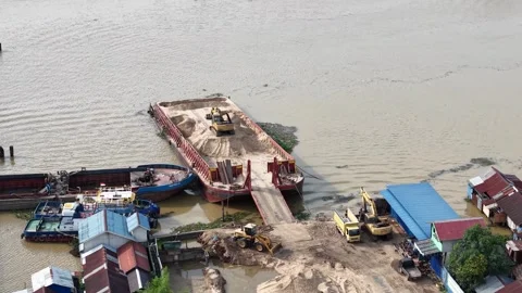 Aerial view of a barge transporting sand during the unloading process using.. Stock Footage 336473925