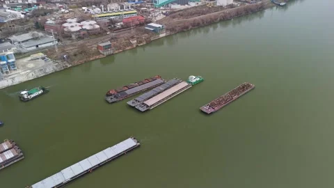 Aerial view of barges moving on the Danube beside Csepel's industrial port Stock Footage 336468345