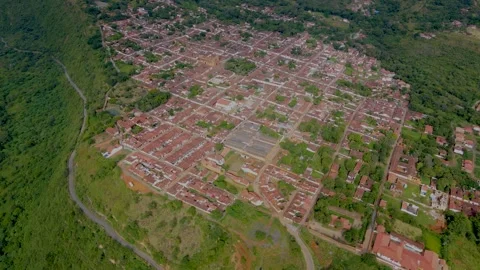 Aerial view of Barichara with brown rooftops and green hills Stock Footage 329950199