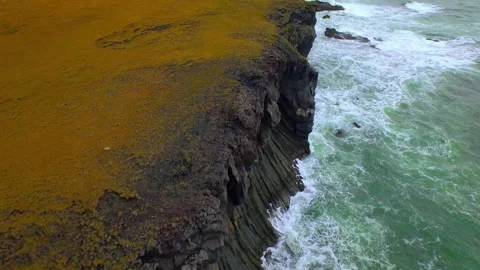 Aerial view of basalt cliffs and ocean waves in Iceland Stock Footage 330267367