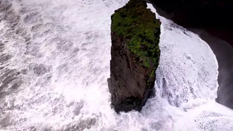 Aerial View of a Basalt Sea Stack on a Dark Volcanic Beach in Iceland Stock Footage 341212952