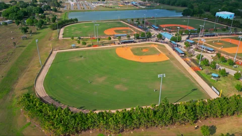Aerial View Of Baseball Fields Next To A Small Lake - Baseball Diamond In Stock Footage 237610892