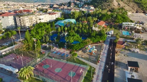 Aerial View: Basketball enthusiasts play a high-energy game on a court Stock Footage 296091053