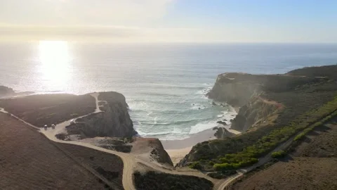Aerial view of bay protected by high cliffs during sunset Vídeo Stock 149773930