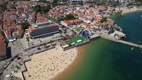 An aerial view of a beach and the surrounding cityscape in Portugal with the Stock Footage 277903571