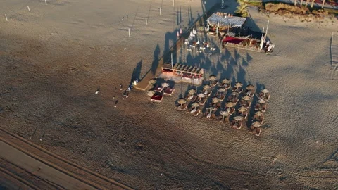 Aerial view of beach bar and umbrellas at golden hour Video stock 344529284