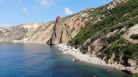 Aerial view beach between steep rocky cliff and blue sea Video stock 103182720