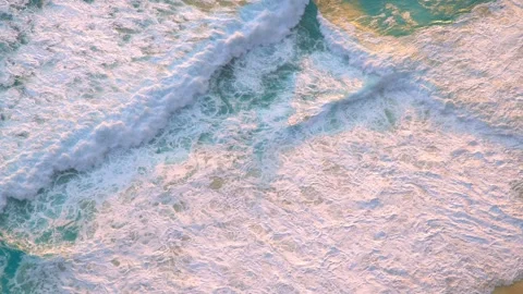 Aerial view of a beach with a blue ocean with waves crushing on a sandy shore Stock Footage 273144232