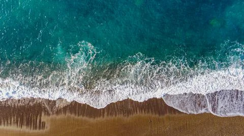 Aerial view of the beach with breaking waves-Cinematic Edit Stock Photos