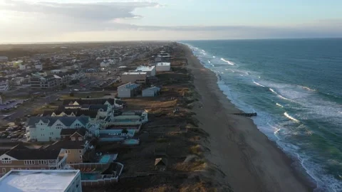 Aerial View of the beach in Kill Devil Hills Outer Banks during Golden Hour Stock Footage 247992051