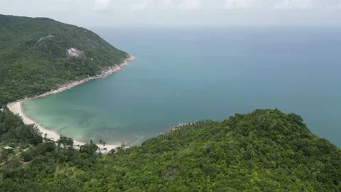 Aerial view of a beach in Ko Pha Ngan, Thailand above a jungle national park Stock Footage 233701250