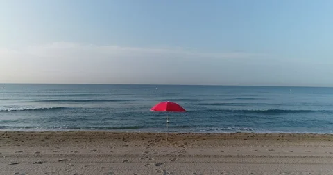 Aerial view of a beach red umbrella Stock Footage 101097618