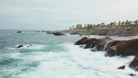 Aerial view of a beach with rocks and waves during the day in Los Cabos Stock Footage 280446773