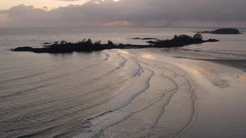 Aerial View Of A Beach At Sunset With Reflections In The Water Stock-Footage 104528687