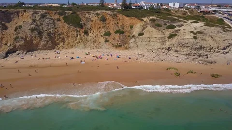 Aerial View at the Beach with Waves and Tourists Stock Footage 130068497
