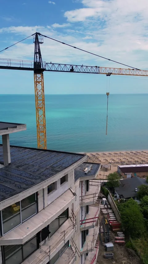 Aerial View of Beachfront Building Construction and Tower Crane Video stock 339169559