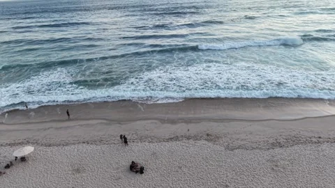 Aerial View of Beachgoers and Waves at Maresias Beach Видео 340529569