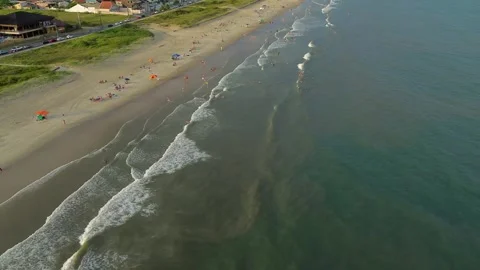 Aerial view of beachgoers enjoying the waves at Matinhos, Brazil Video stock 329078177