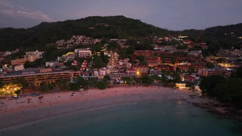 Aerial view of beachside resort area at dusk with illuminated buildings and Vídeos de archivo 342312935