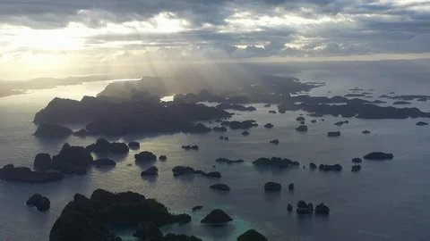 Aerial View of Beams of Light Falling on Limestone Islands in Raja Ampat Stock Footage 120945909