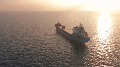 Aerial view. Beatiful sunset at the sea. Huge cargo ship floating in the sea. Stock Footage 122841336