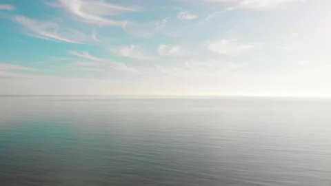 Aerial view of beautiful calm open sea with feather clouds on a sunny day.  Stock Footage 140280241