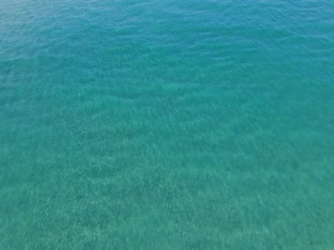 Aerial view of beautiful ocean with different sea colors  and jet ski Stock Footage 78248144
