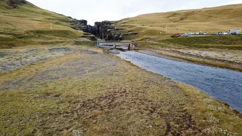 Aerial view of beautiful river flowing amidst canyon at moss covered landscape Stock Footage