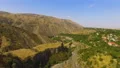 Aerial view of beautiful rolling hills, canyons and charming small village 4k or 4k+ Resolution